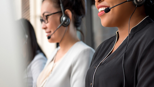 Member service representatives wearing a headset with a microphone talking to Members on the phone.