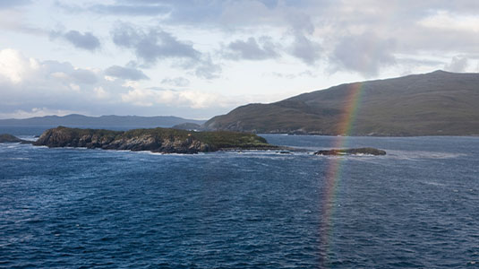 Rainbow over the coastline near Cape Horn