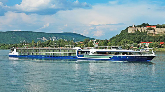 Avalon cruise ship gliding on water.