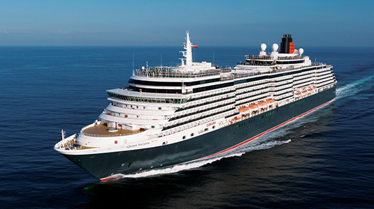 Cunard cruise ship gliding over water.